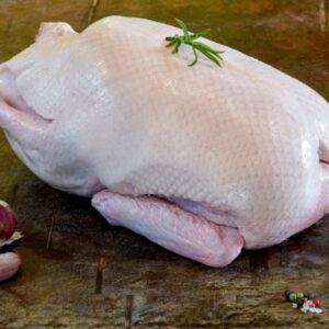 A whole duck on a wooden surface