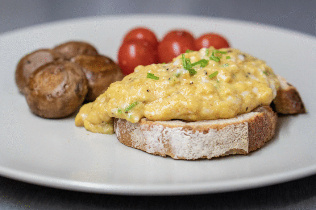 scrambled eggs on sourdough toast with tomatos and potatos