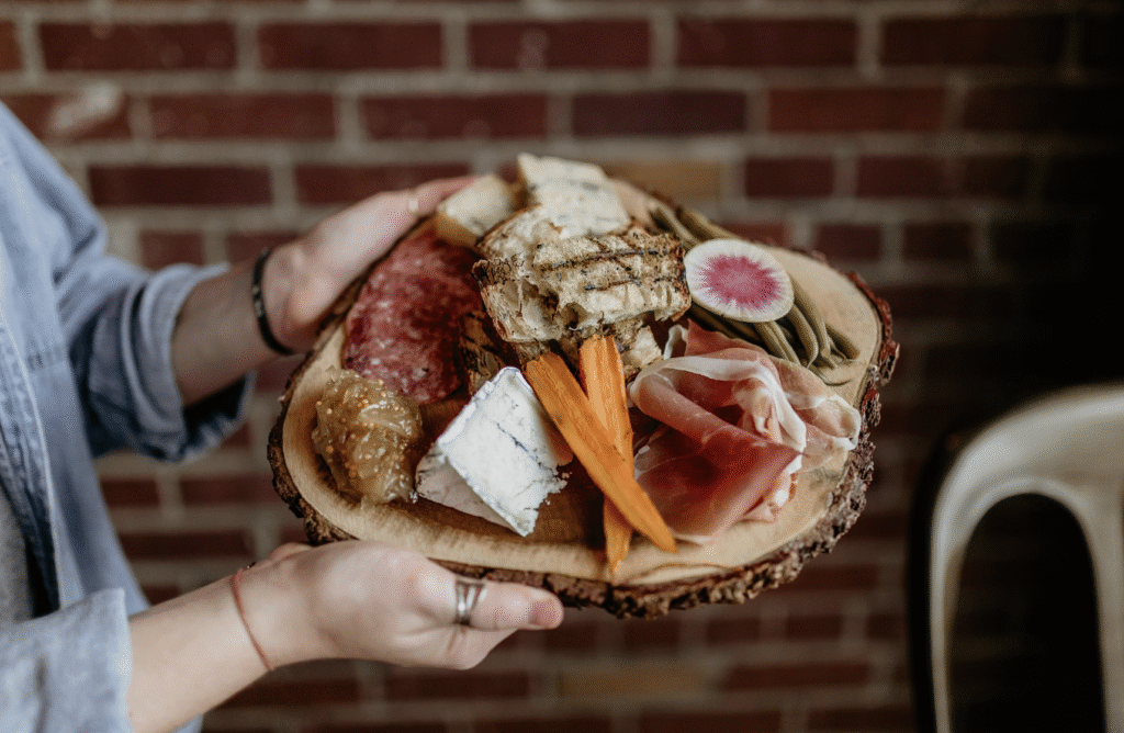 Charcuterie Pack (Salami, Coppa, Proscuttio) with figs and cheese on a wooden board