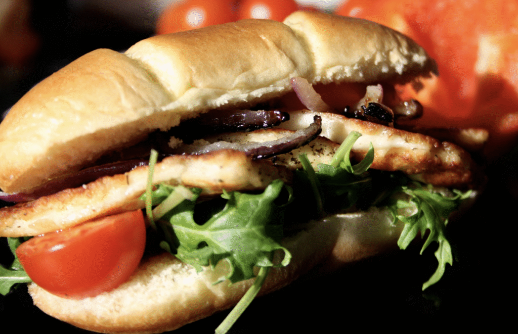 Grilled halloumi in a bun with meat and salad