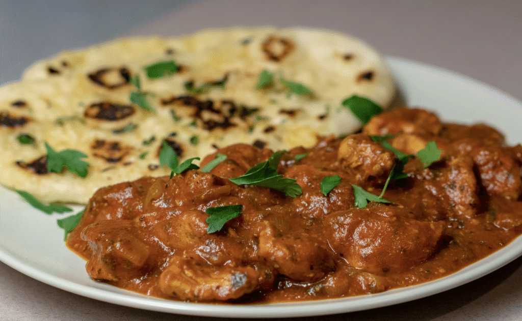 Madhuban Jalfrezi Curry with chicken and naan bread on a plate
