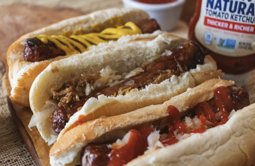 Smoked Bratwurst Sausages in buns with sauce on them