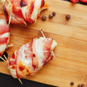 Crispy Bacon wrapped in chicken on a wooden board