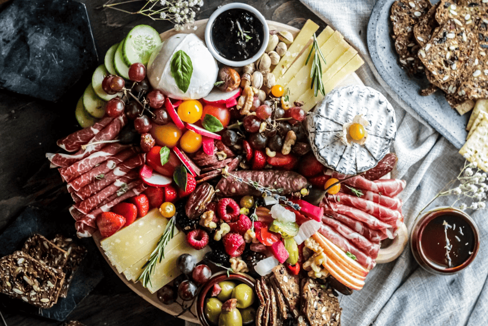 festive packed cheese board with meats, fruit and cheeses