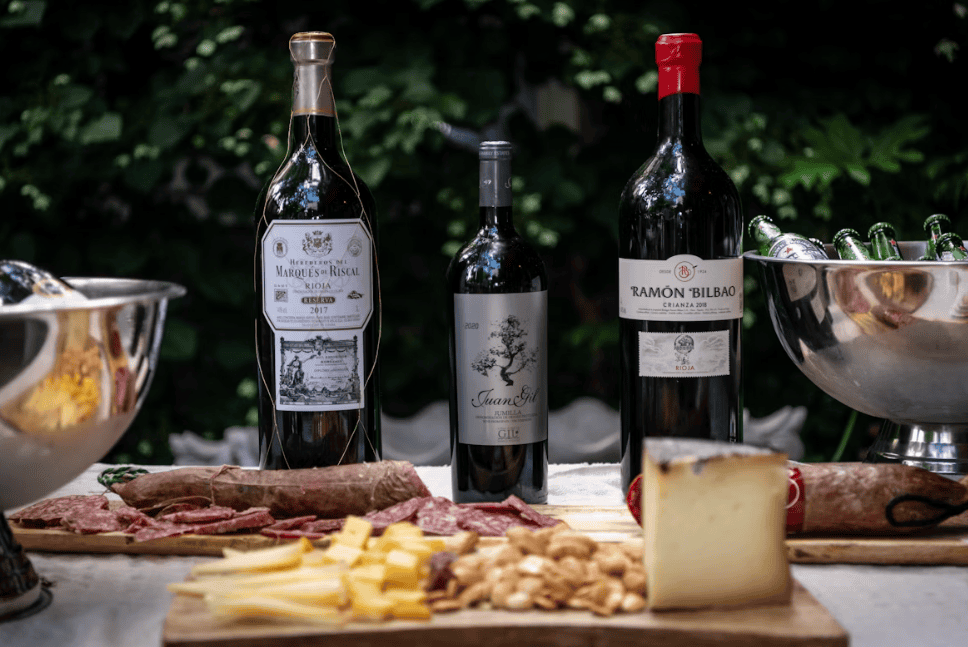 wine, cheese and cured meats on a table