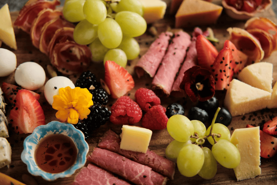 cheese platter with fruit and meats