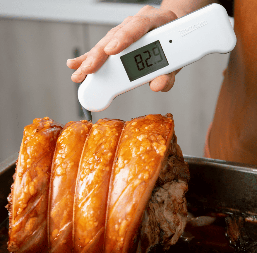 joint of pork with a meat thermometer in it