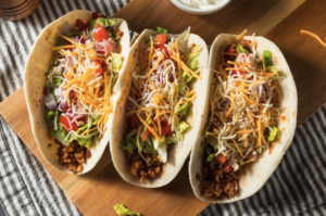 beef tacos loaded with salad and cheese