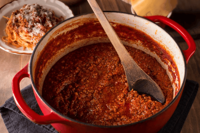 Bolognese sauce and meat in a cooking pot