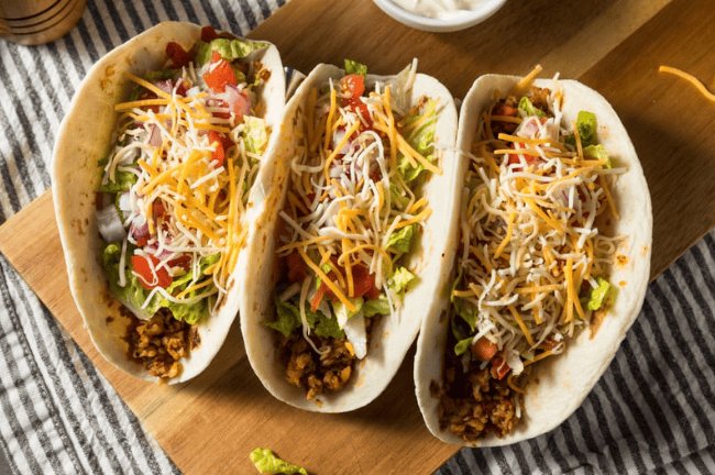beef tacos loaded with salad and cheese