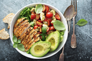 chicken, avocado and salad in a bowl